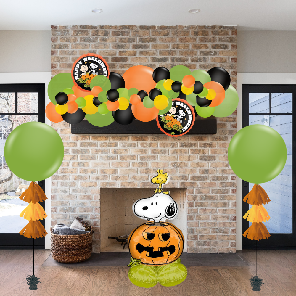 Halloween-themed decorations including balloons and a Snoopy pumpkin in front of a fireplace.