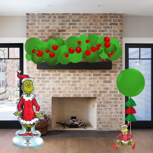 Decorative Grinch figures and wreath on a brick fireplace